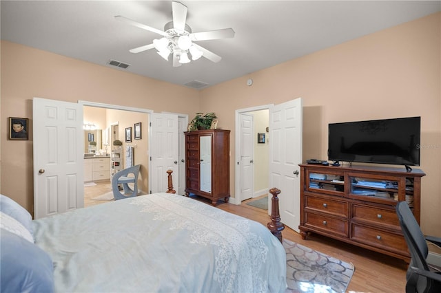 bedroom with a ceiling fan, visible vents, light wood finished floors, and ensuite bathroom