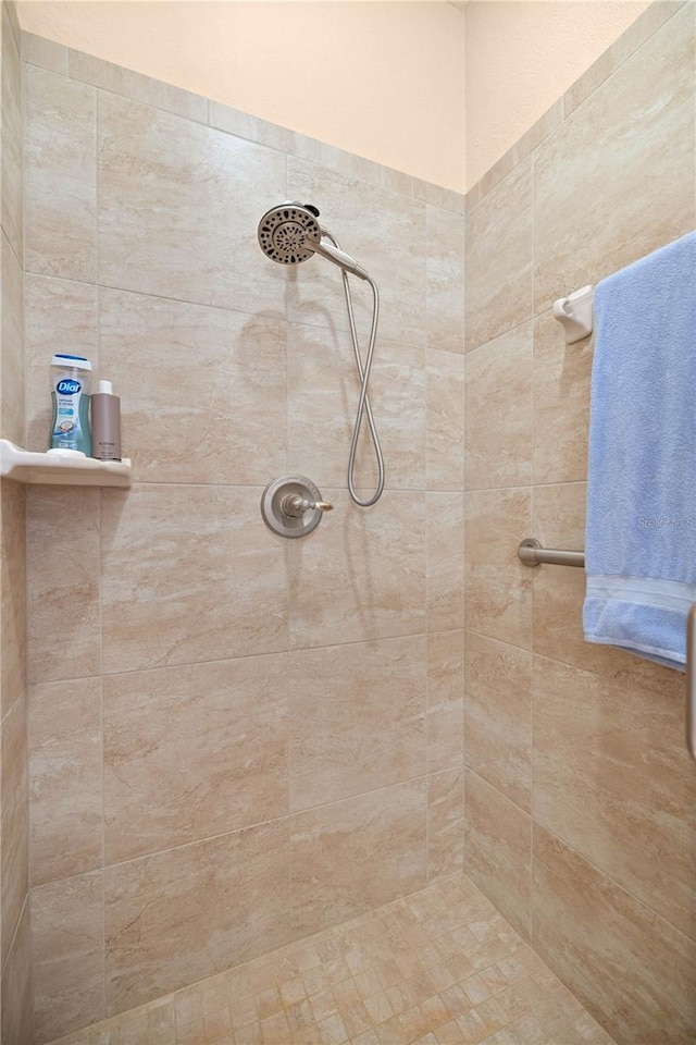 bathroom with tiled shower