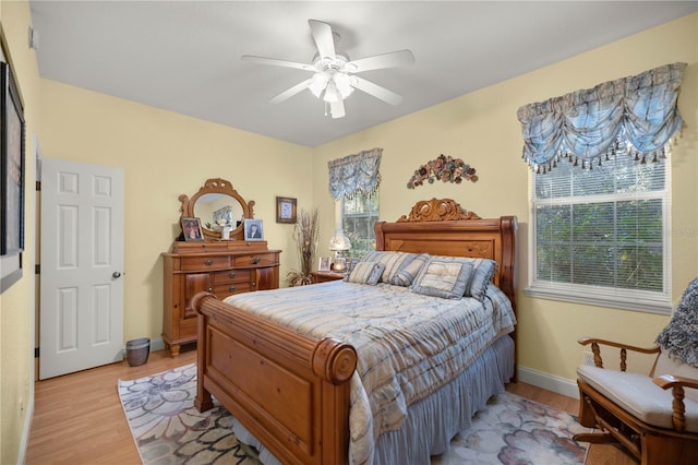 bedroom featuring light wood-type flooring, ceiling fan, and baseboards