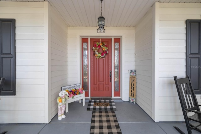 view of exterior entry with a porch