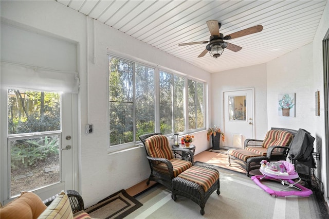 sunroom featuring wood ceiling and ceiling fan