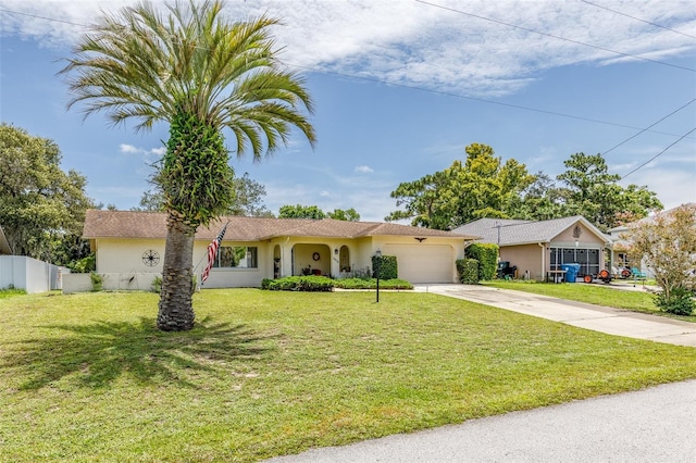 single story home featuring driveway, a garage, fence, a front lawn, and stucco siding