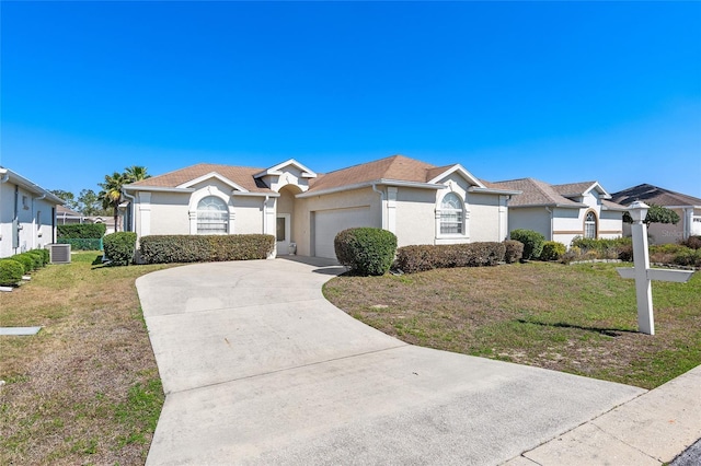 view of front facade featuring an attached garage, central AC, concrete driveway, stucco siding, and a front yard