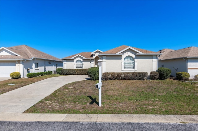 ranch-style house with driveway, a front lawn, and stucco siding