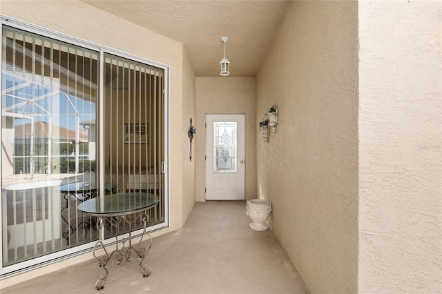 view of exterior entry featuring stucco siding