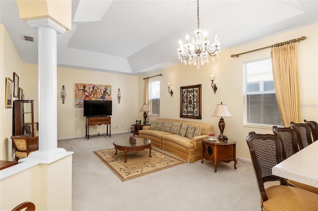 living room featuring visible vents, a healthy amount of sunlight, decorative columns, and light carpet