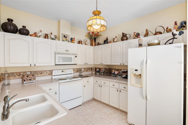 kitchen featuring light tile patterned floors, white appliances, a sink, white cabinets, and pendant lighting