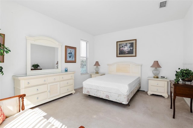 bedroom with light colored carpet and visible vents