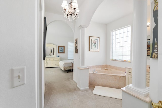 full bath with a bath, a notable chandelier, ornate columns, and ensuite bathroom