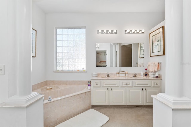 full bathroom with a sink, a bath, and ornate columns