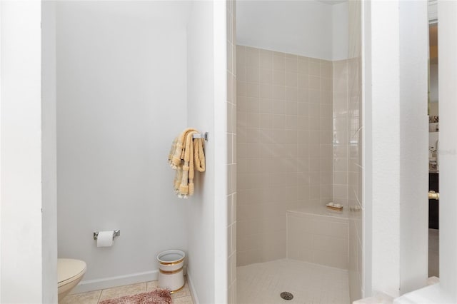 full bath featuring a stall shower, baseboards, toilet, and tile patterned floors