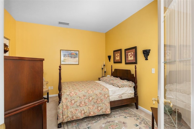 carpeted bedroom featuring visible vents and baseboards