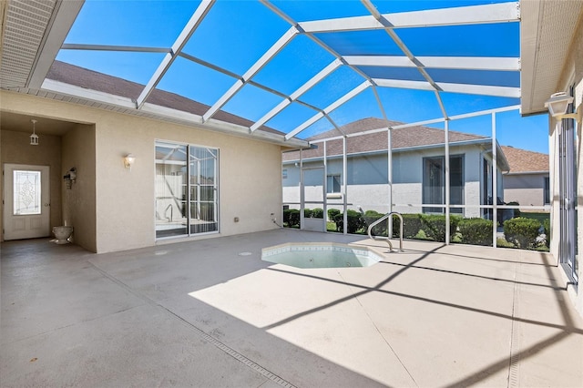 view of swimming pool with glass enclosure and a patio area