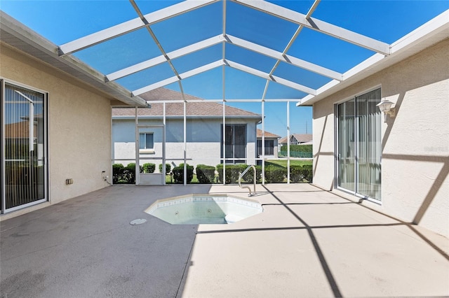 view of pool with a lanai, a patio, a sink, and an in ground hot tub