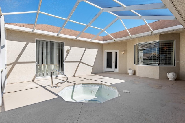 view of swimming pool with glass enclosure, a patio area, and a hot tub