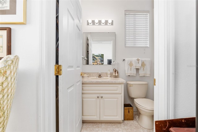 bathroom with vanity, tile patterned flooring, and toilet