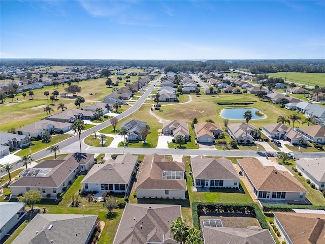 birds eye view of property with view of golf course, a water view, and a residential view