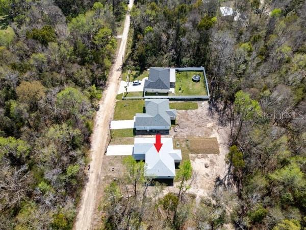 drone / aerial view featuring a view of trees