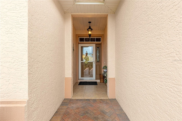 entrance to property featuring stucco siding