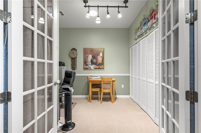 tiled home office featuring baseboards, visible vents, track lighting, and french doors