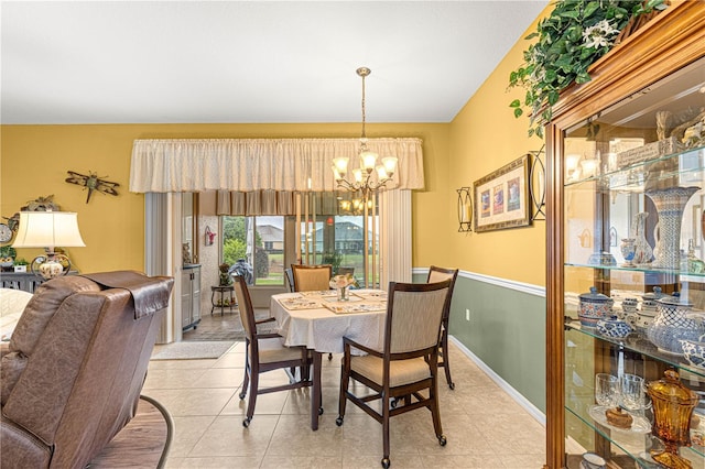 dining area featuring a chandelier, baseboards, and light tile patterned floors