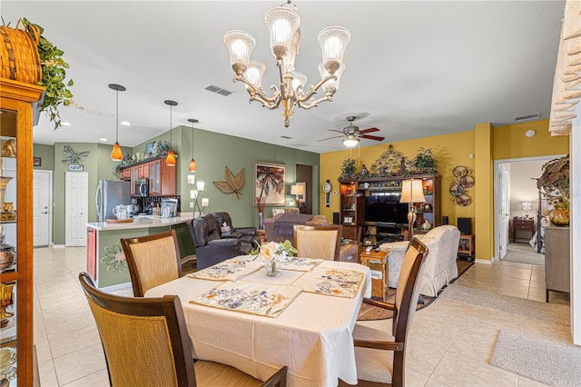 dining area with ceiling fan with notable chandelier, light tile patterned floors, and visible vents