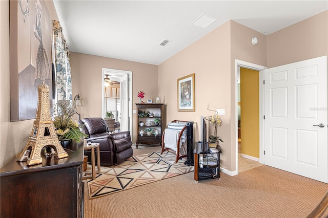 sitting room with light colored carpet, visible vents, and baseboards