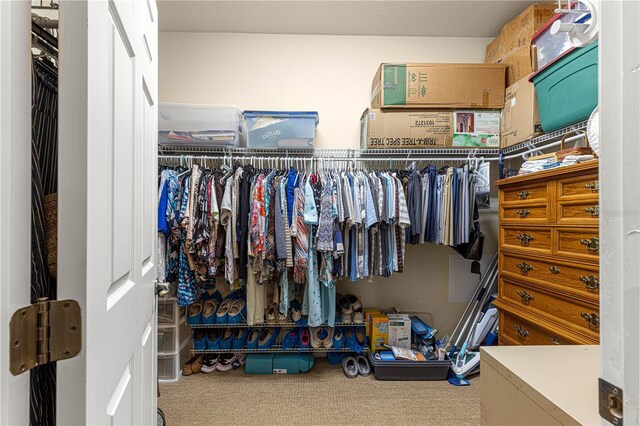 walk in closet with carpet