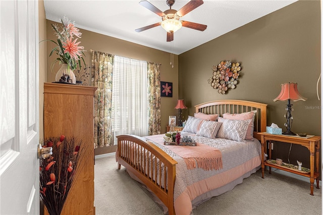 bedroom with ceiling fan and light colored carpet