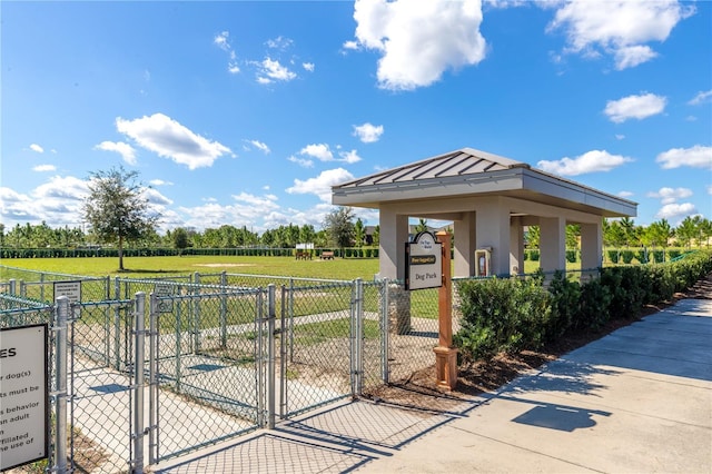 surrounding community featuring a rural view, a gate, fence, and a yard