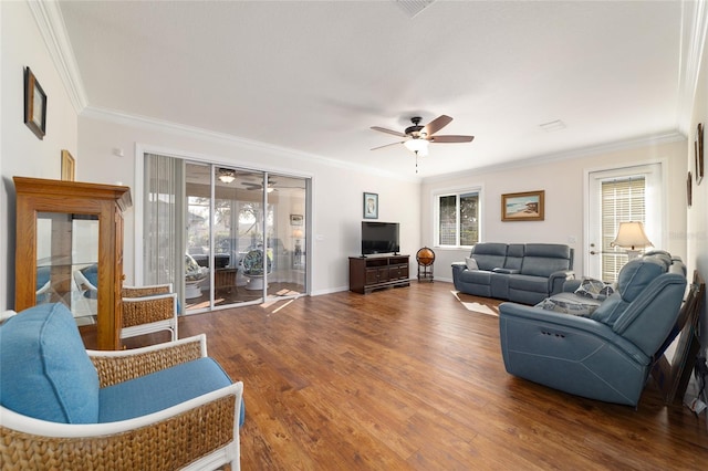 living area with baseboards, crown molding, a ceiling fan, and wood finished floors