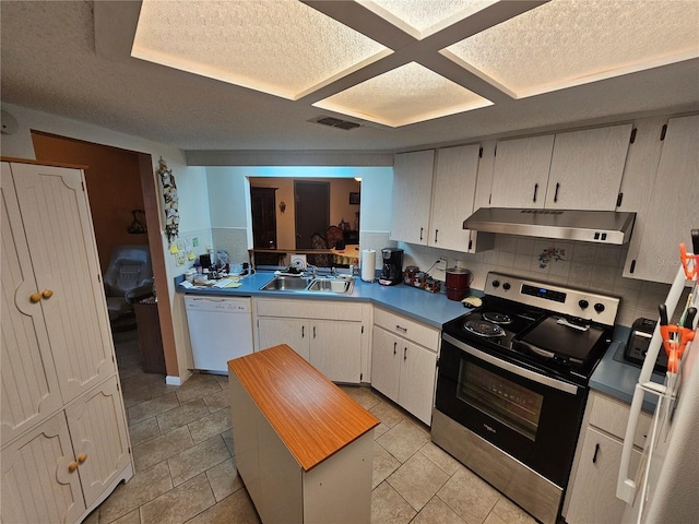 kitchen featuring white dishwasher, under cabinet range hood, a sink, visible vents, and stainless steel range with electric cooktop