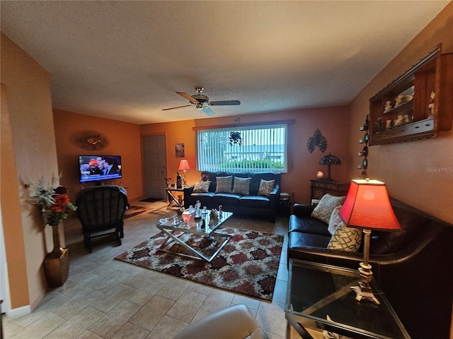 living area with a ceiling fan and a textured ceiling