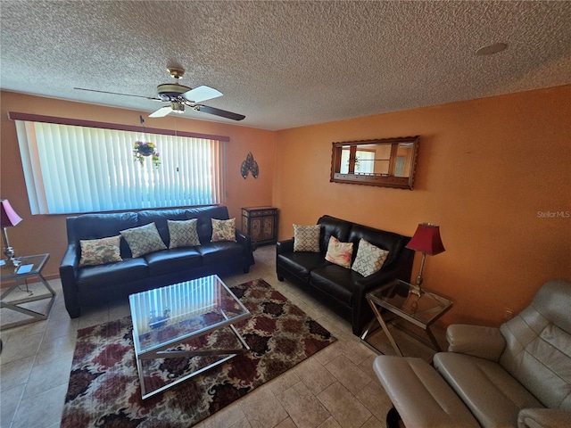 living area featuring ceiling fan and a textured ceiling