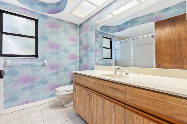 bathroom with toilet, a shower stall, vanity, and tile patterned floors