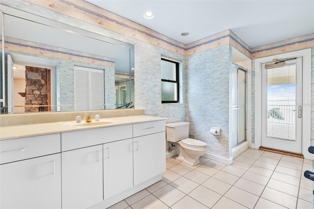 full bath with toilet, a shower stall, vanity, and tile patterned floors