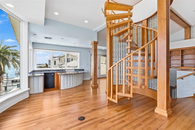 interior space featuring recessed lighting, visible vents, light wood-type flooring, dishwasher, and decorative columns