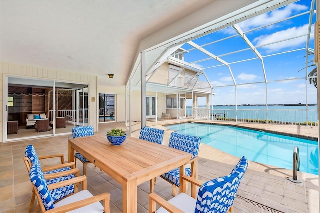 outdoor pool with a water view, glass enclosure, a patio, and french doors