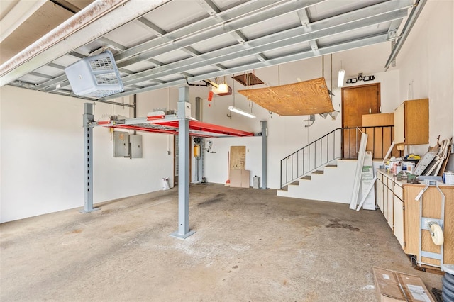 garage featuring a garage door opener and electric panel