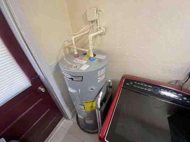 utility room with electric water heater