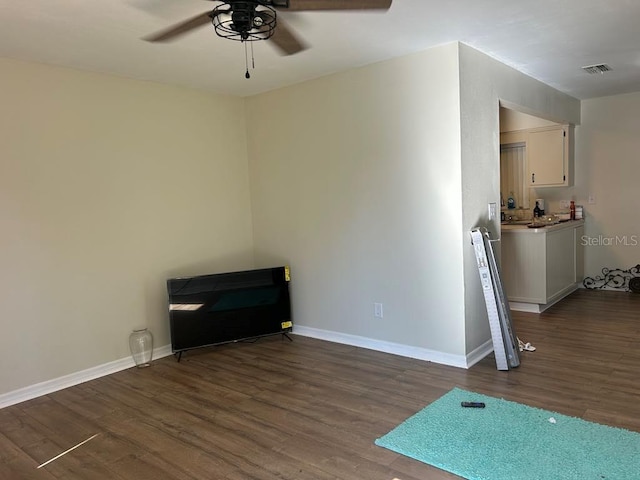 empty room featuring baseboards, visible vents, ceiling fan, and wood finished floors