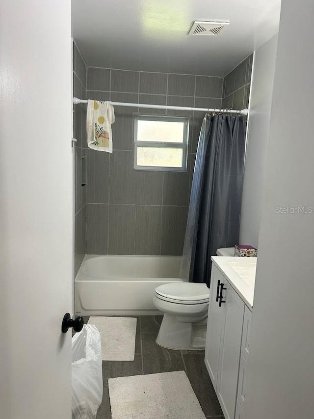 bathroom with toilet, shower / bath combo, visible vents, and vanity