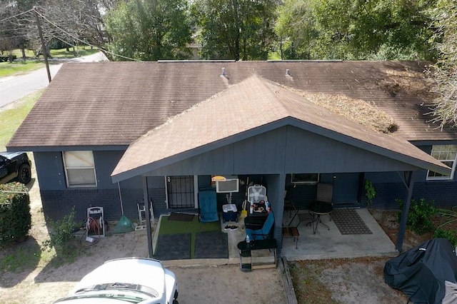 view of front of property featuring a patio area and brick siding