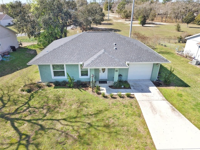 view of front of property with a garage, a shingled roof, driveway, stucco siding, and a front lawn