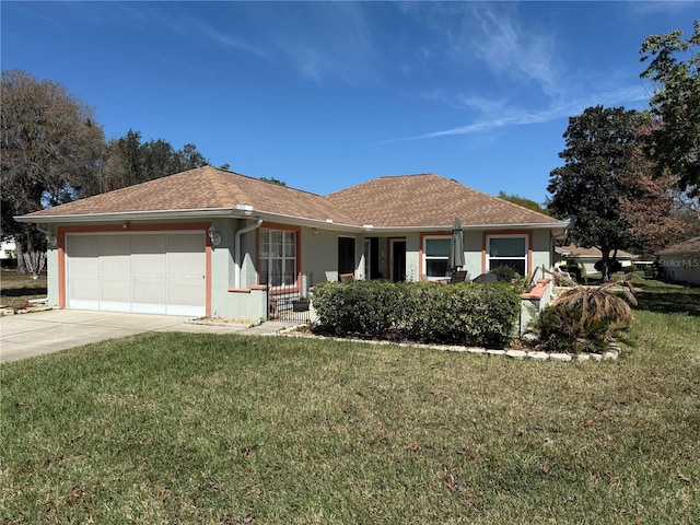 ranch-style house featuring concrete driveway, roof with shingles, an attached garage, a front yard, and stucco siding