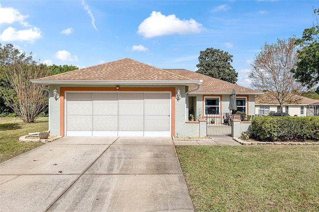 ranch-style house with roof with shingles, stucco siding, a front yard, a garage, and driveway