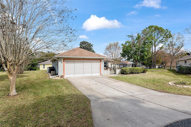 single story home with a garage, driveway, a front lawn, and stucco siding