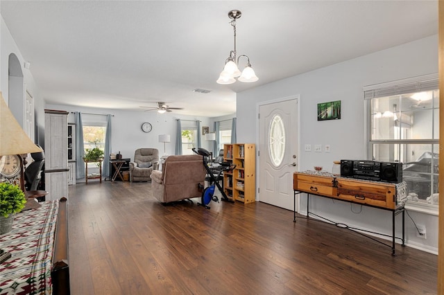 entryway with dark wood-style floors, visible vents, and ceiling fan with notable chandelier