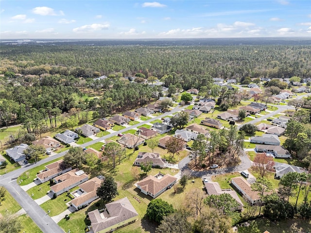 drone / aerial view with a forest view and a residential view