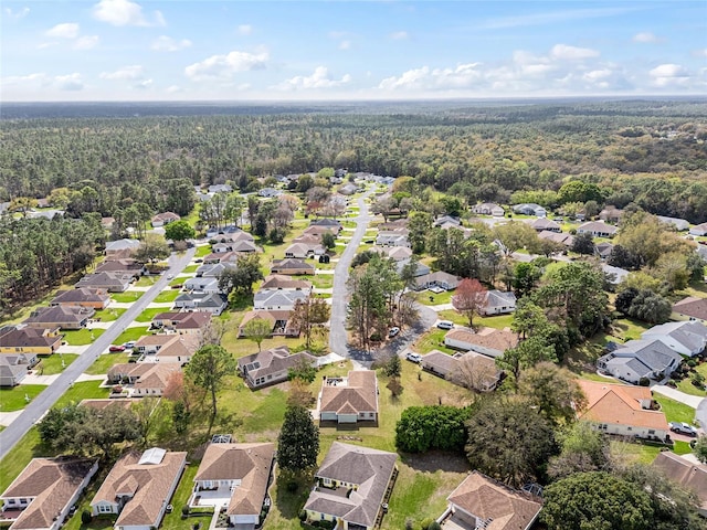 aerial view featuring a residential view and a wooded view